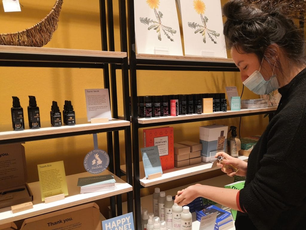 Woman shopping for sustainable brands in Blue Patch's Happy Planet Store