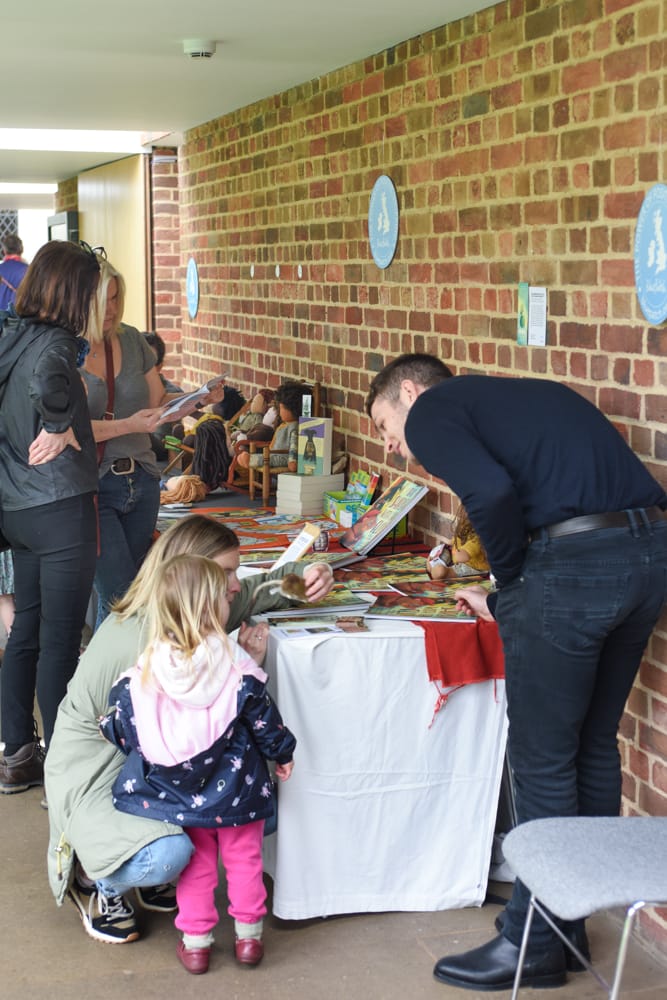 Little girl talking to children's book author Will Hamilton -Davies at Dulwich Picture Gallery